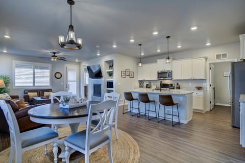 Large kitchen with stainless steel appliances, granite countertops, an island with three barstools, and all the essentials for your extended stay!
