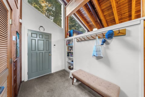 Entryway with built-in storage and bench seating.