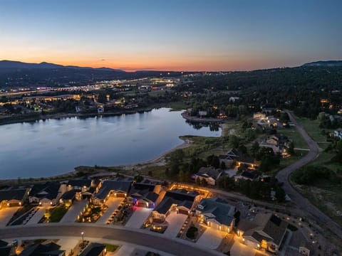 Framed by twinkling lights and mountains' silhouettes - your luxury stay!