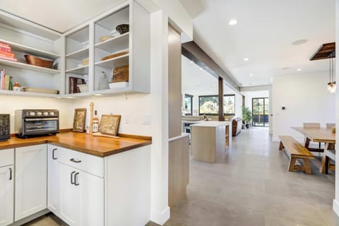 The prep space connects seamlessly to the kitchen and dining areas, creating an open, airy layout designed for effortless entertaining and everyday comfort.