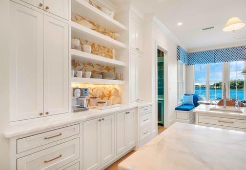 Dining area with coastal-inspired design and elegant lighting.
