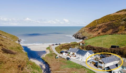Aerial view of the house, beach and the surrounding properties.