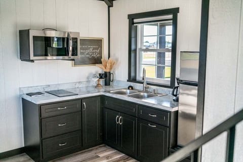 The kitchenette is equipped with a microwave, refrigerator, drip coffee maker, and hot plate.