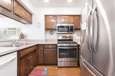 The kitchen is fully stocked with dishes, utensils, glassware, bakeware, cookware, and both large and small appliances