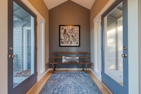 Hallway with wall art and bright natural light.