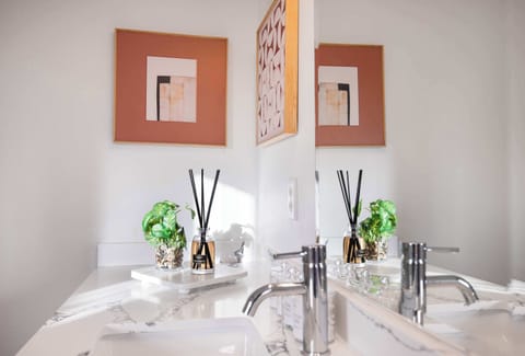 Chic vanity setup with greenery and soft lighting.