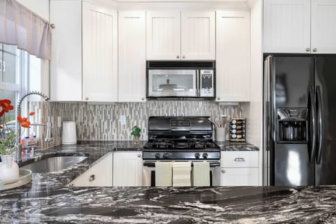 Modern cooking space featuring stainless steel appliances and gas stove.