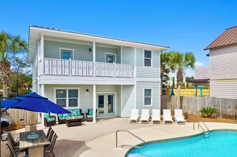 Just steps from the beach, Sun-Kissed is an 8-bedroom luxury villa that sleeps 22 and features a private heated pool, FREE golf cart, and a fun game room with air hockey and arcade games—perfect for unforgettable family vacations and group getaways!