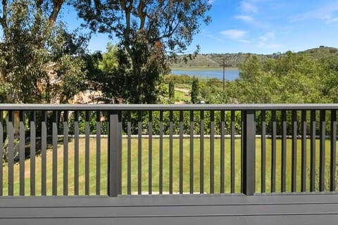 Spacious deck perfect for outdoor dining and relaxing under the stars, with stunning views of Lake Hodges in a serene setting.
