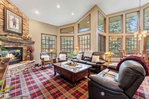 Living room (main floor): Gas fireplace, Smart TV, balcony access, radiant heat