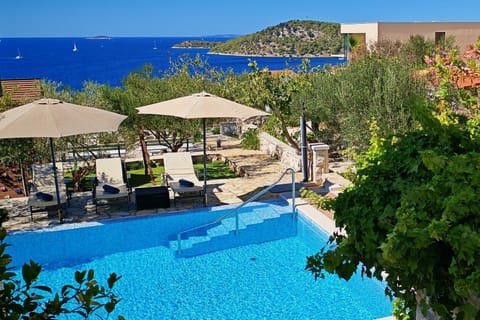 The private pool and sun deck offer stunning sea views over the Adriatic and nearby islands, highlighting the villa's beautiful location.
