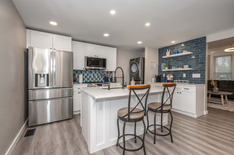 The chic, open kitchen offers ample space & all the comforts of home