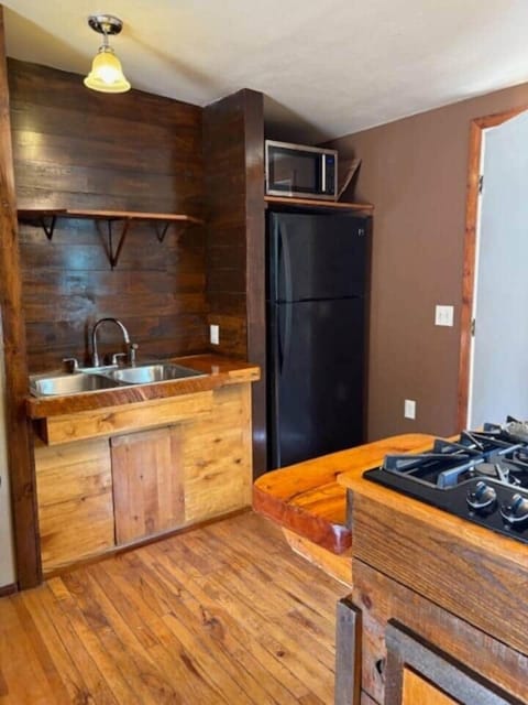 This view of the kitchen highlights the full-sized refrigerator.