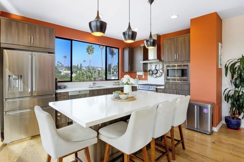 Modern kitchen with an island and stainless steel appliances.