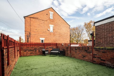 Relax outdoors with a cup of tea in the peaceful garden seating area.