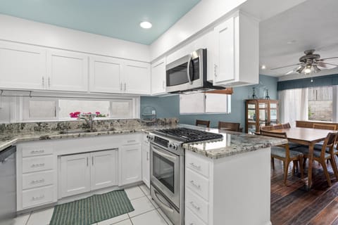 The kitchen is fully stocked with dishes, utensils, cookware, bakeware, and all major and small appliances