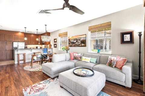 Natural light fills the open-concept living area, designed for easy lounging and connection to indoor-outdoor dining.