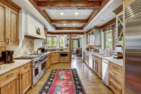 Gourmet chef’s kitchen with premium appliances, custom wood cabinetry, and cozy breakfast nook.
