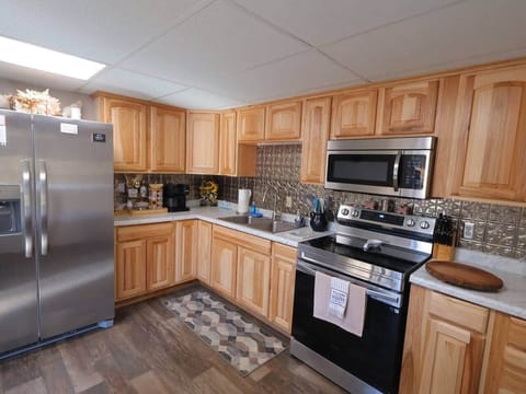 Spacious kitchen with cookware, utensils, and modern appliances