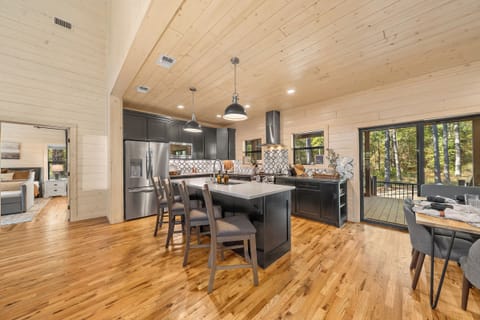 Design forward kitchen with large island, custom tile, and sightlines that keep the cook connected to the whole group.