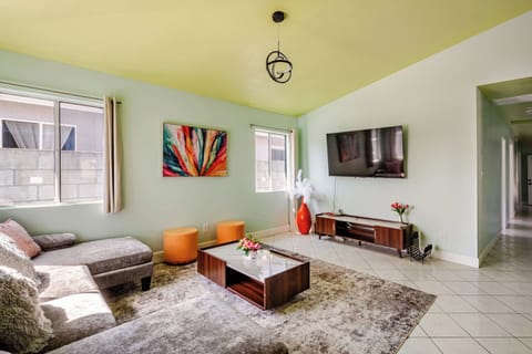 Bright and cozy living room with a large sectional, smart TV, and open layout.