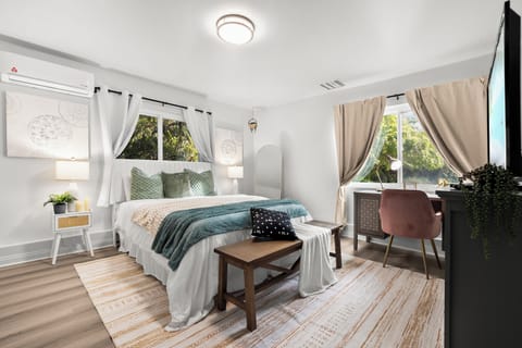 Work and unwind! This bedroom features a cozy workspace for productivity.