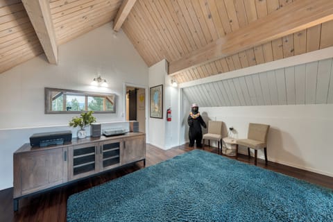 Spacious loft lounge featuring a record player and cozy seating, complete with fun Tahoe character..