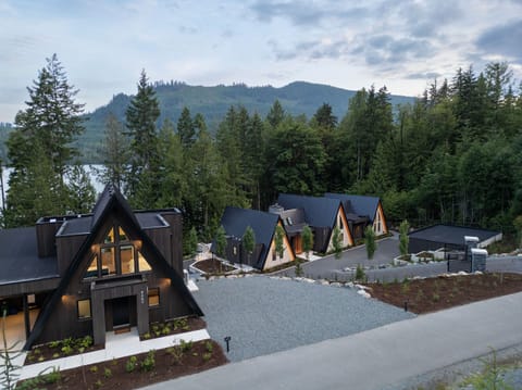 View of one of the cabins (left) and main house (right)