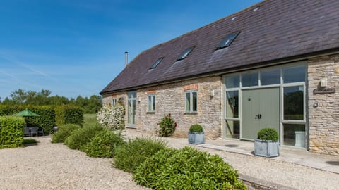 Just outside is a private dining terrace with a table and chairs and a charcoal barbecue.