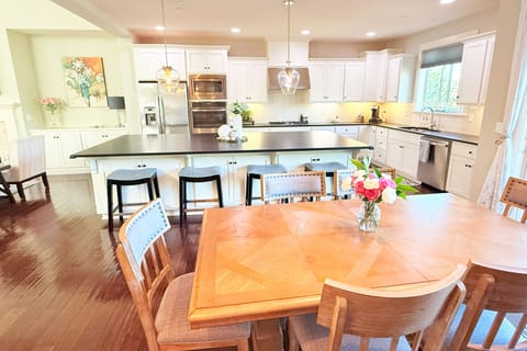 Kitchen table has a leaf and two additional chairs to seat 8 adults.