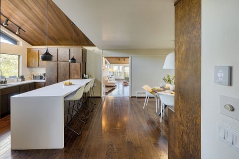 Modern kitchen with a spacious island, pendant lighting, and stunning natural light.