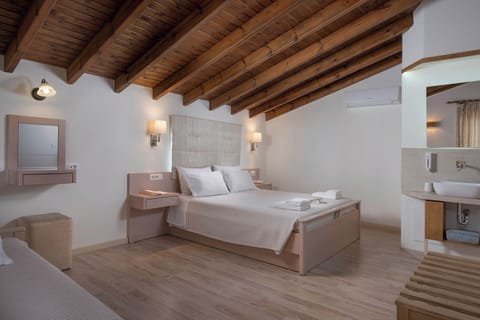 Experience a Romantic and Comfortable Night's Sleep in the Cozy Double Bed, Surrounded by Pastel Colors. A Convenient Bathroom Adds to Your Relaxation.