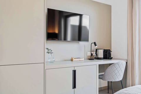  Desk space with a coffee maker and kettle for added convenience.