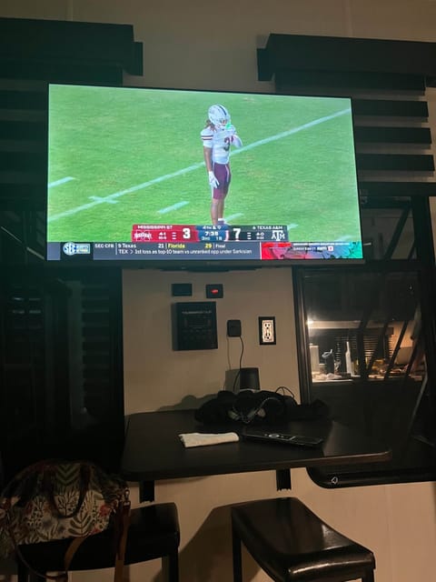 Smart TV and dining workspace — perfect for dinner, game day, or catching up on emails.