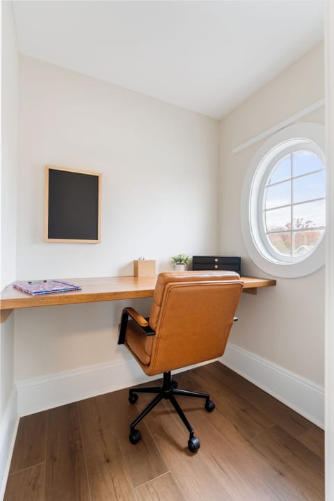 dedicated in-room office area with desk and workspace