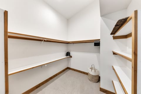 Large walk-in closet in primary suite with plenty of space for clothing or travel crib (not provided).