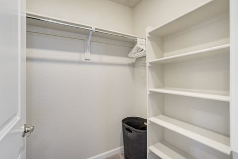 Attached bath with dual vanities, walk-in shower and walk-in closet.