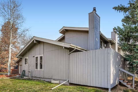 Your peaceful retreat awaits in this charming contemporary home, where warm wood siding and soaring chimneys create the perfect blend of rustic comfort and modern style for your getaway.
