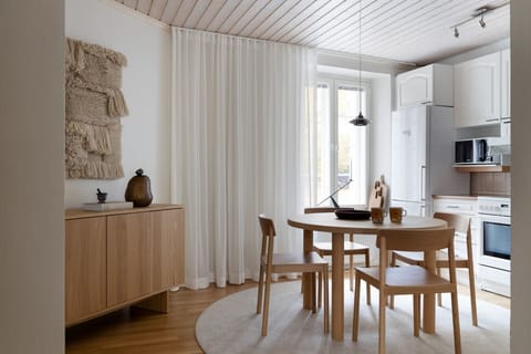 A bright dining area offers comfortable seating for four—perfect for casual meals or work.