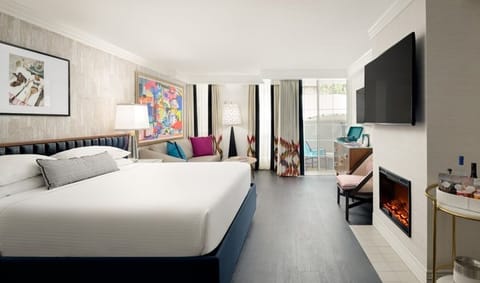 Unwind in a spacious suite with balcony and glowing fireplace.