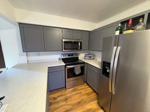 Your fully equipped kitchen features modern stainless steel appliances, granite countertops, and plenty of cabinet space for all your culinary needs.