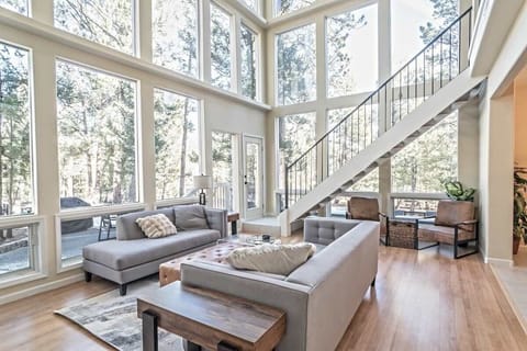 Step into the open-concept living room with floor to ceiling windows