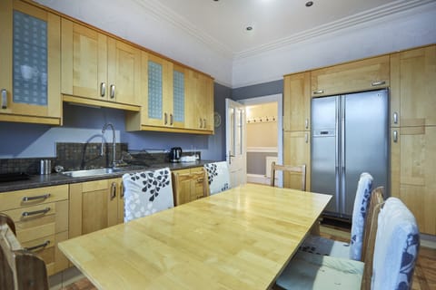Spacious kitchen with appliances and essentials.