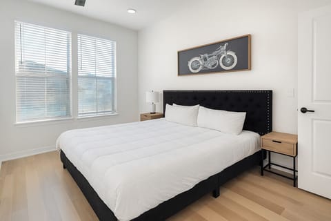 Plush king bed with blackout curtains and cold A/C for deep sleep after long shifts