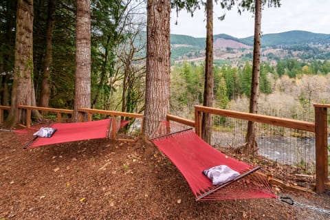 Unwind in the riverside hammock grove, tucked beneath towering trees with peaceful mountain views—your perfect spot for reading, napping, or simply breathing in the forest air.