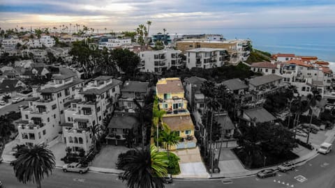 Aerial view of coastal neighborhood leading to the ocean, highlighting the property’s prime location