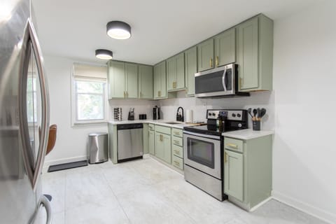 Spacious full kitchen featuring stainless steel and modern appliances.