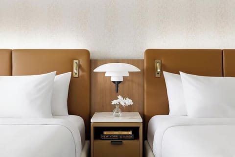 Recharge under warm designer lighting between two inviting beds.