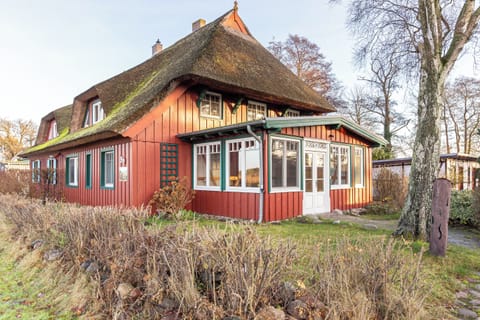 Exterior view of a holiday house with a red facade