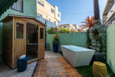 A peaceful outdoor wellness corner with an infrared sauna and cold plunge, offering a refreshing way to unwind during your stay.